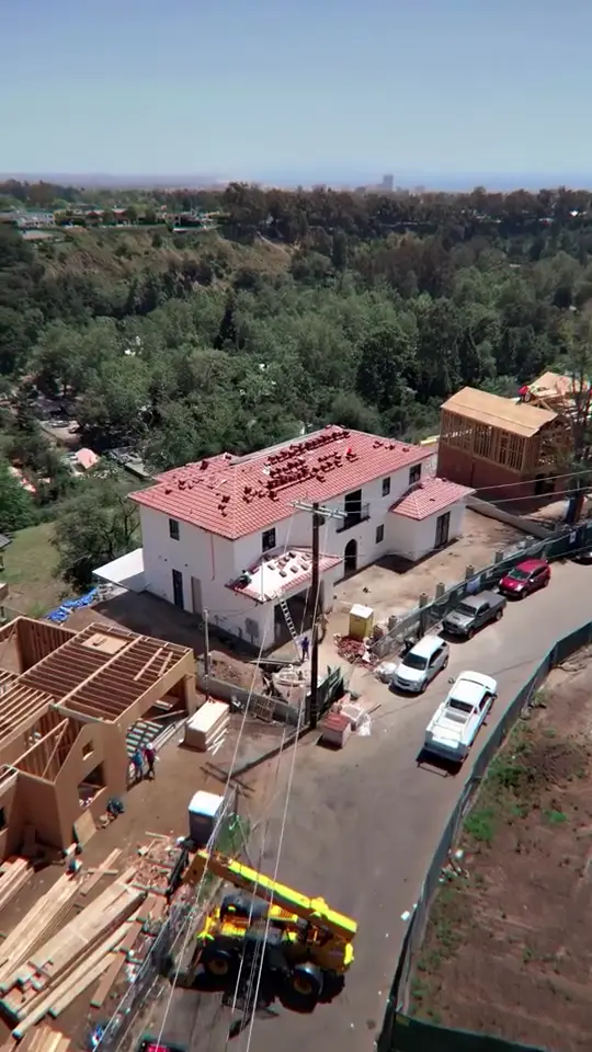 Tile roof install — New clay tile going down on a two-story Spanish-style home.