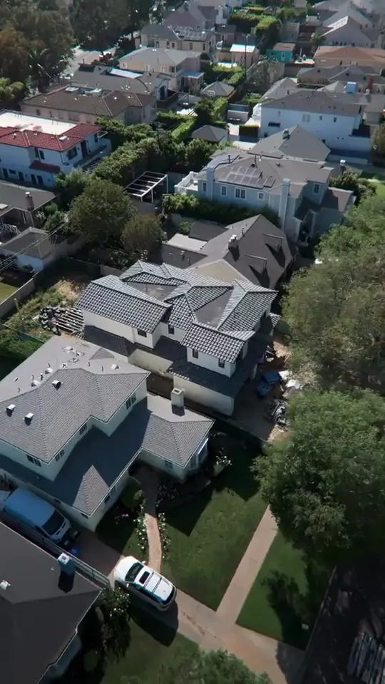 Finished roofline — New roof finished on a two-story home, seen from directly above.